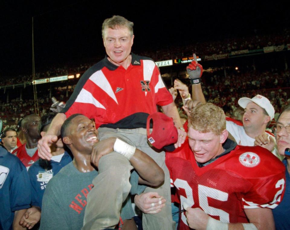 FILE - In this Jan. 1, 1995, file photo, Nebraska players carry coach Tom Osborne off the field after the Huskers defeated Miami 24-17 in the Orange Bowl NCAA college football game in Miami. Osborne is giving up his large skybox at Memorial Stadium, saying the Nebraska athletic department should sell it to someone else rather than have him continue to use it for free. The 80-year-old Osborne coached the Cornhuskers for 25 years, retiring after the 1997 season with 255 wins and all or part of three national championships three of his last four years. He was the school's athletic director from 2007-12. (AP Photo/Doug Mills, File)