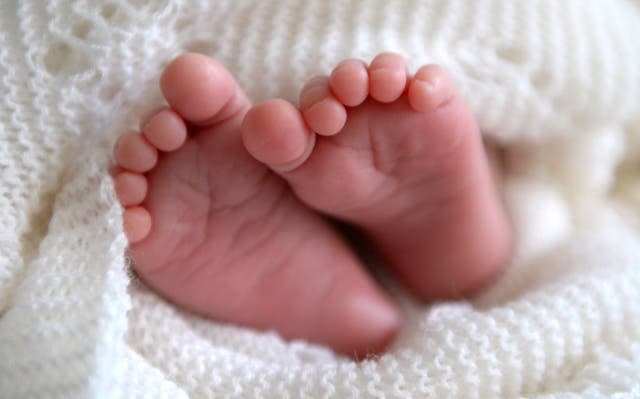 A new born baby’s feet (Andrew Matthews/PA)