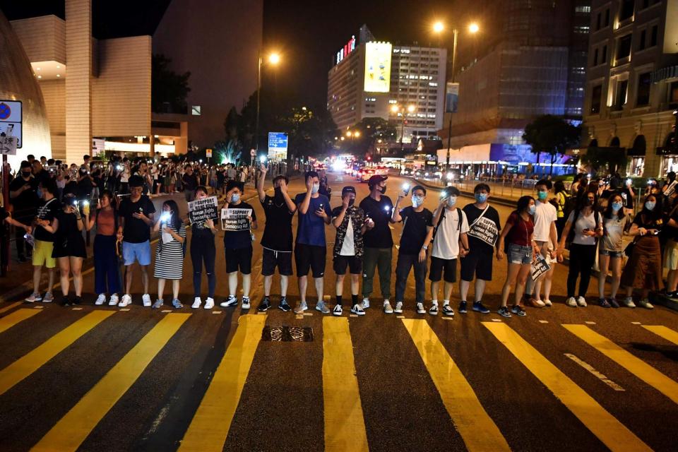 Protesters form a human chain on the street outside the Hong Kong Cultural Centre. (AFP/Getty Images)