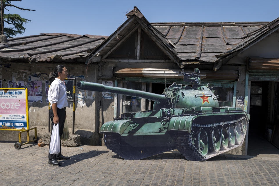 A young exile Tibetan stands in front of a cardboard cutout of a tank to replicate the 'tank man', an iconic moment in the Tiananmen Square pro-democracy protests in 1989, in Dharmsala, India, Saturday, June 4, 2022. Saturday marks the anniversary of China’s bloody 1989 crackdown on pro-democracy protests at Beijing’s Tiananmen Square. (AP Photo/Ashwini Bhatia)