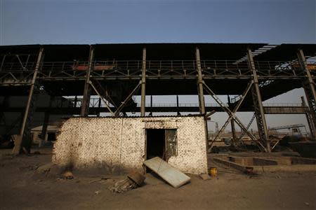 A damaged house is pictured inside an abandoned steel mill of Qingquan Steel Group in Qianying township, Hebei province February 18, 2014. REUTERS/Petar Kujundzic