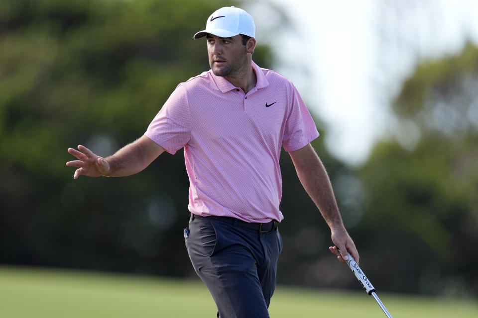 Scottie Scheffler acknowledges the gallery on the 10th green during the third round of The Sentry golf event, Saturday, Jan. 6, 2024, at Kapalua Plantation Course in Kapalua, Hawaii. (AP Photo/Matt York)