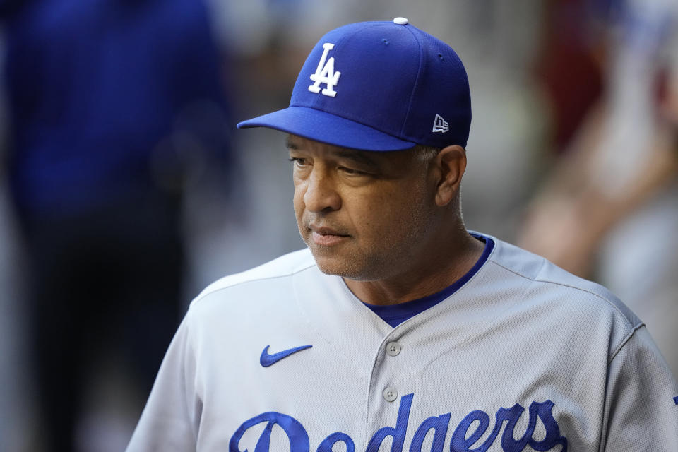Los Angeles Dodgers manager Dave Roberts pauses in the dugout prior to Game 3 of a baseball NL Division Series against the Arizona Diamondbacks Wednesday, Oct. 11, 2023, in Phoenix. The Diamondbacks won 4-2. (AP Photo/Ross D. Franklin)