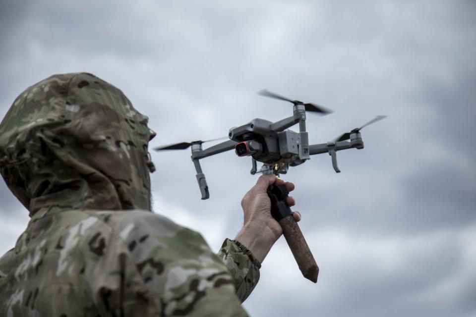 A Ukrainian serviceman attach a 3D version of an explosive as he trains to drop explosives devices from a drone in a secret location in Lviv Oblast, Ukraine, on May 12th, 2023.