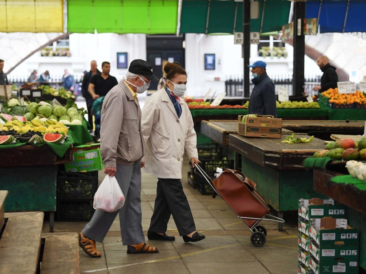 Shoppers wear face masks asthey shop in Leicester Market in Leicester, Britain, 30 June 2020: EPA