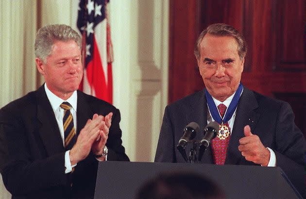 Dole reacts after receiving the Presidential Medal of Freedom from President Bill Clinton at the White House in 1997. (Photo: JOYCE NALTCHAYAN via Getty Images)