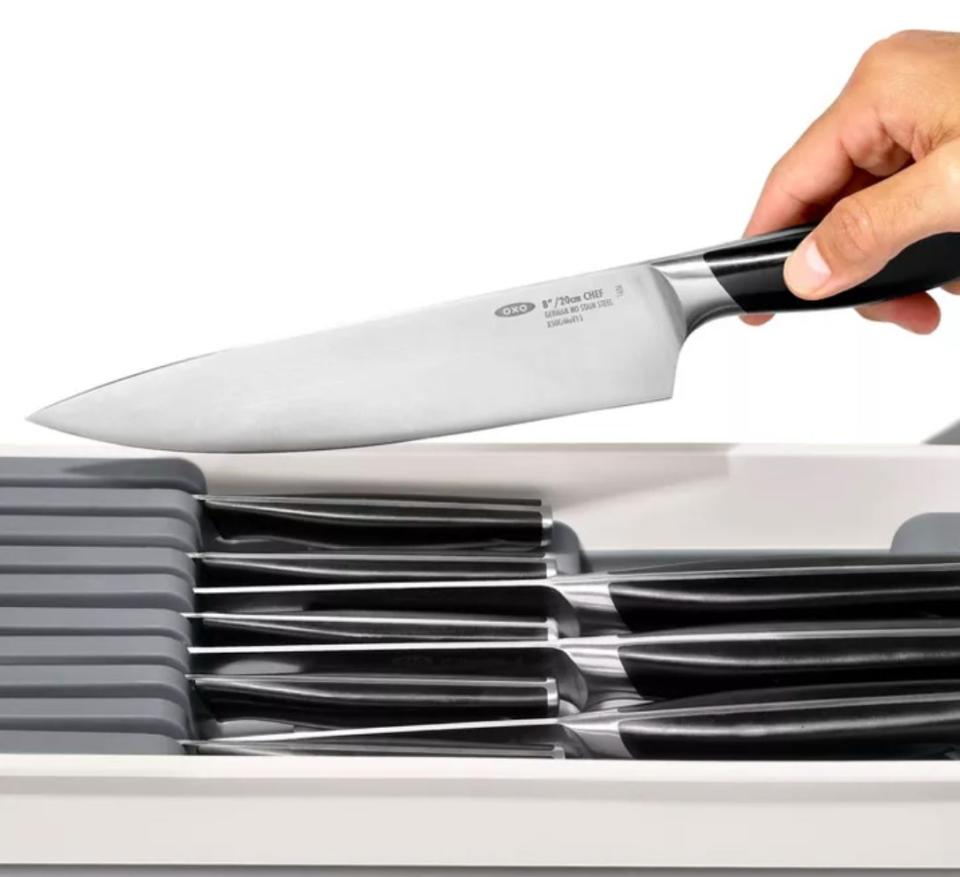 a knife entering a plastic organizer