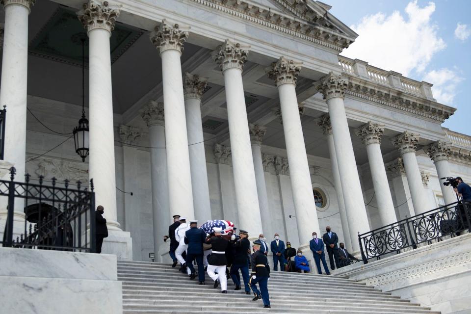 <p>Onlookers watched as Lewis's flag-draped casket was walked into the Capitol building by a joint services military honor guard. Lewis served Georgia's 5th congressional district from 1987 until his death.</p>