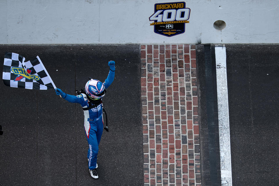 INDIANAPOLIS, INDIANA - 21 JULI: Kyle Larson, coureur van de #5 HendrickCars.com Chevrolet, viert feest met de geblokte vlag na het winnen van de NASCAR Cup Series Brickyard 400 op Indianapolis Motor Speedway op 21 juli 2024 in Indianapolis, Indiana.  (Foto door James Gilbert/Getty Images)