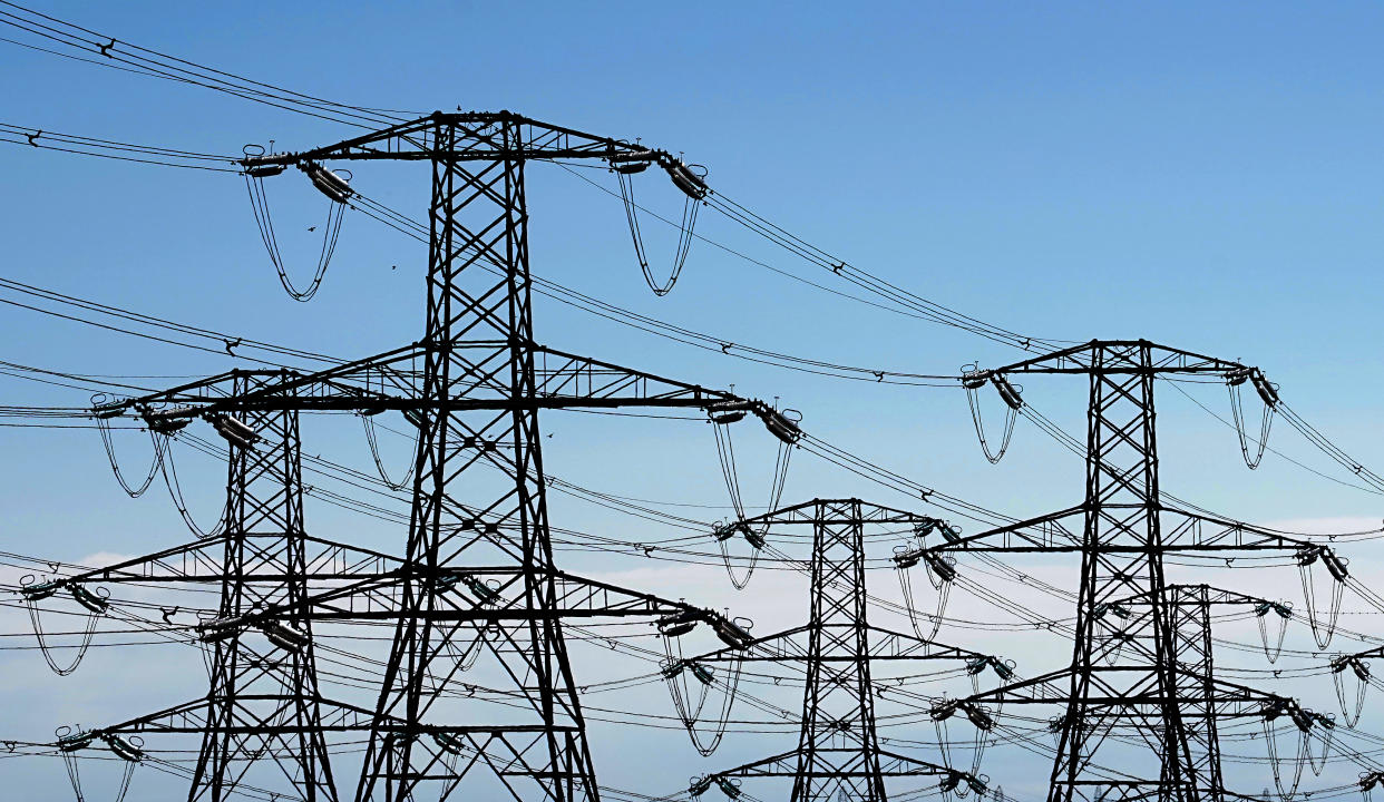 Electricity pylons run across Romney Marsh in Kent from Dungeness nuclear power station. Ofgem has confirmed an 80.06 percent rise in the energy price cap, sending the average household's yearly bill from GBP 1,971 to GBP 3,549 from October. Picture date: Thursday August 25, 2022. (Photo by Gareth Fuller/PA Images via Getty Images)