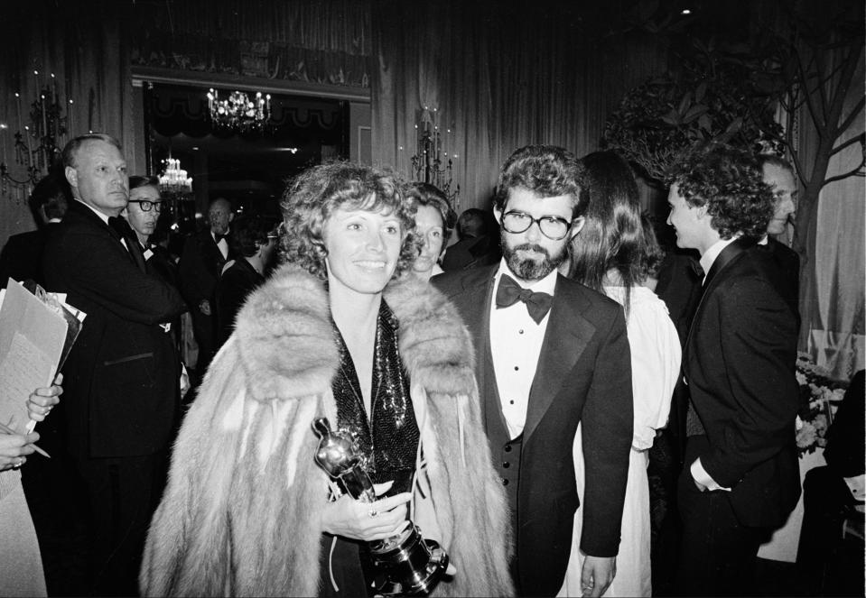 Marcia Lucas, wife of director George Lucas, right, carries her Oscar statuette as they arrive at a post Academy Awards party at the Beverly Hilton Hotel in Los Angeles, Ca., April 4, 1978.  She won for best achievement in film editing for "Star Wars," directed by her husband.  (AP Photo)