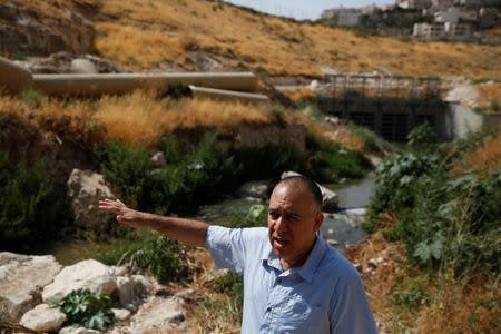 Shony Goldberger, director of the Jerusalem district in Israel's Environmental Protection Ministry speaks during an interview with Reuters as sewage flows in the Kidron Valley, on the outskirts of Jerusalem July 6, 2017. Picture taken July 6, 2017. REUTERS/Ronen Zvulun