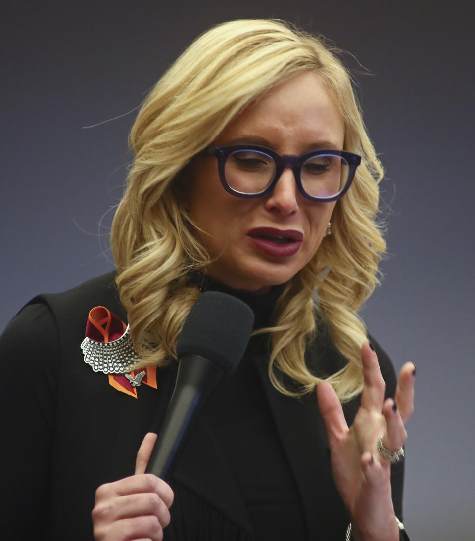 Sen. Lauren Book, D-Plantation, holds back tears as she talks about the shooting victims while debating Senate Bill 7030: Implementation of Legislative Recommendations of the Marjory Stoneman Douglas High School Public Safety Commission, Tuesday, April 23, 2019, in the Florida Senate in Tallahassee, Fla. The bill passed 22-17. (AP Photo/Phil Sears)