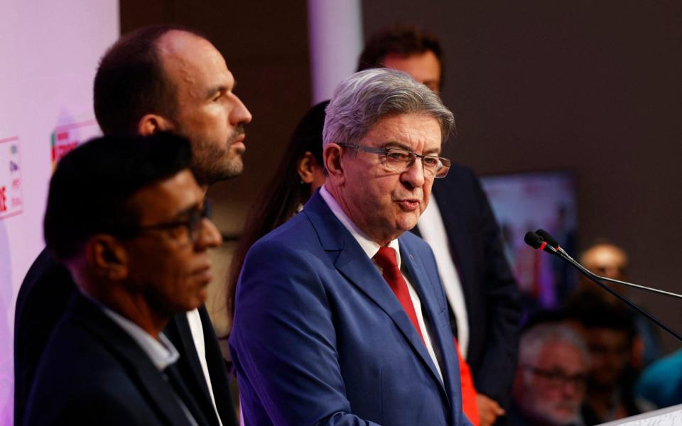 Melenchon speaking on a stage