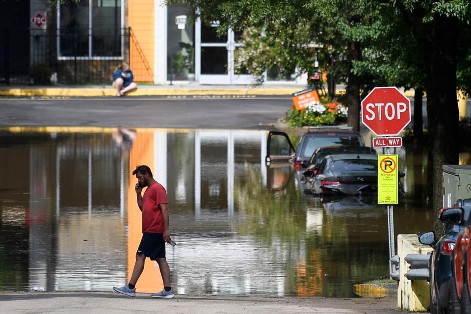 Floods at 23rd Street and Forest Avenue caused damage in Knoxville as a storm system camped out for hours, dumping rain and brightening the sky with lightning.