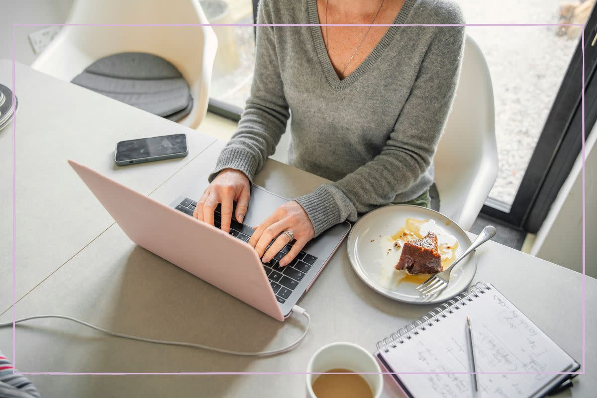  A woman typing on a laptop while working from home. 