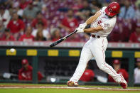 Cincinnati Reds' Max Schrock (32) hits a base hit during the first inning of a baseball game against the Pittsburgh Pirates' in Cincinnati, Tuesday, Sept 21, 2021. (AP Photo/Bryan Woolston)