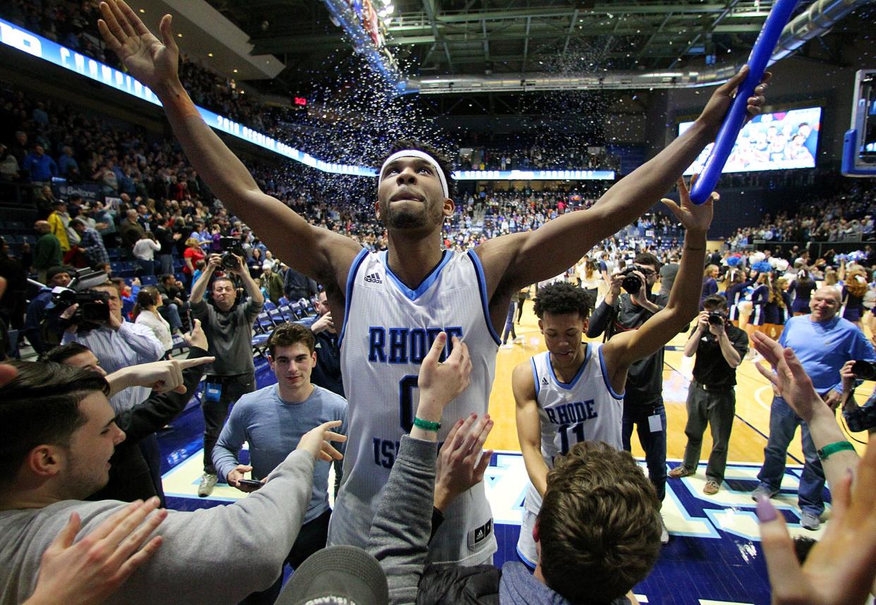 E.C. Matthews celebrates with URI fans in the student section after a 2018 game at the Ryan Center.