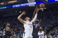 Los Angeles Clippers center Ivica Zubac (40) and Sacramento Kings forward Chimezie Metu (7) reach for a rebound during the first quarter of an NBA basketball game in Sacramento, Calif., Saturday, Dec. 4, 2021. (AP Photo/Randall Benton)
