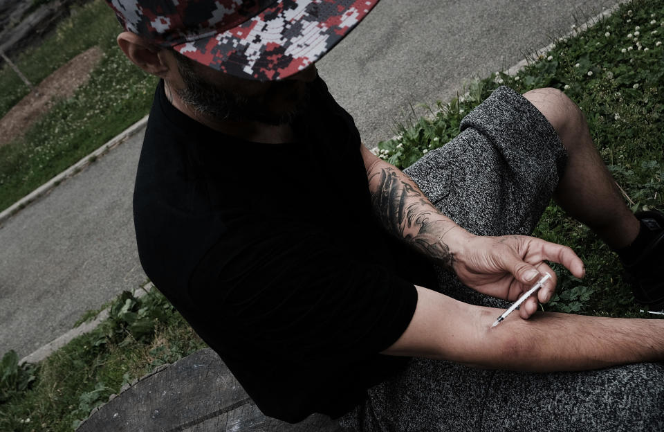 A young man shoots heroin in a park in the South Bronx section of New York City, June 7, 2017. (Photo: Spencer Platt/Getty Images)