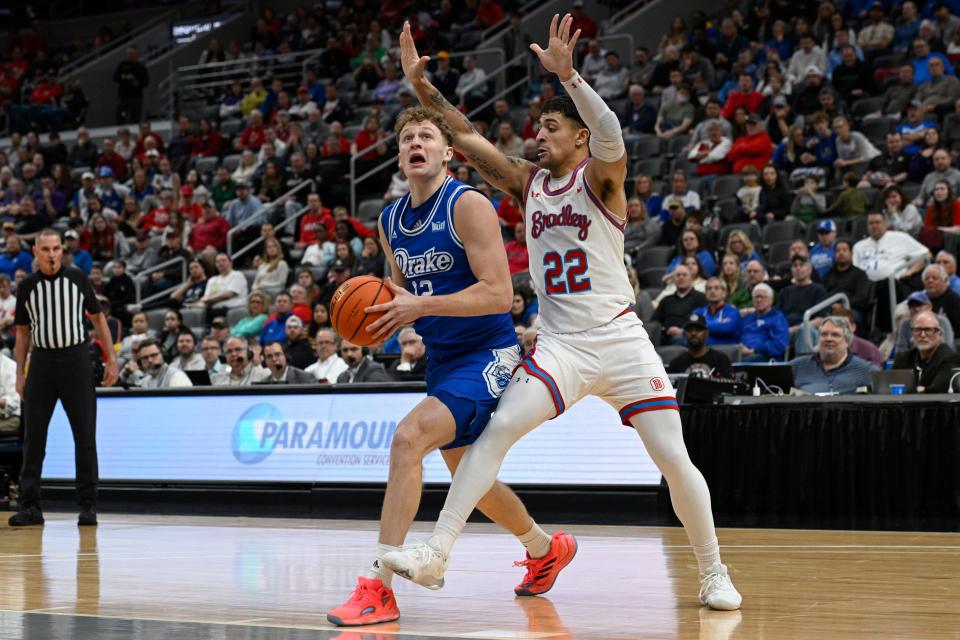 Drake's Tucker DeVries, left, looks to shoot as Bradley's Ja'Shon Henry defends during the championship game of the Missouri Valley Conference tournament on March 5.