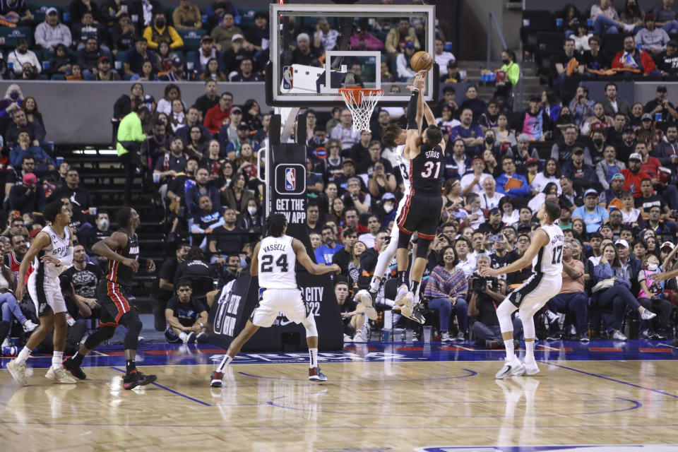 Miami Heat's Max Strus (31) shoots over San Antonio Spurs' Zach Collins during the first half of an NBA basketball game, at the Mexico Arena in Mexico City, Saturday, Dec. 17, 2022. (AP Photo/Christian Palma)