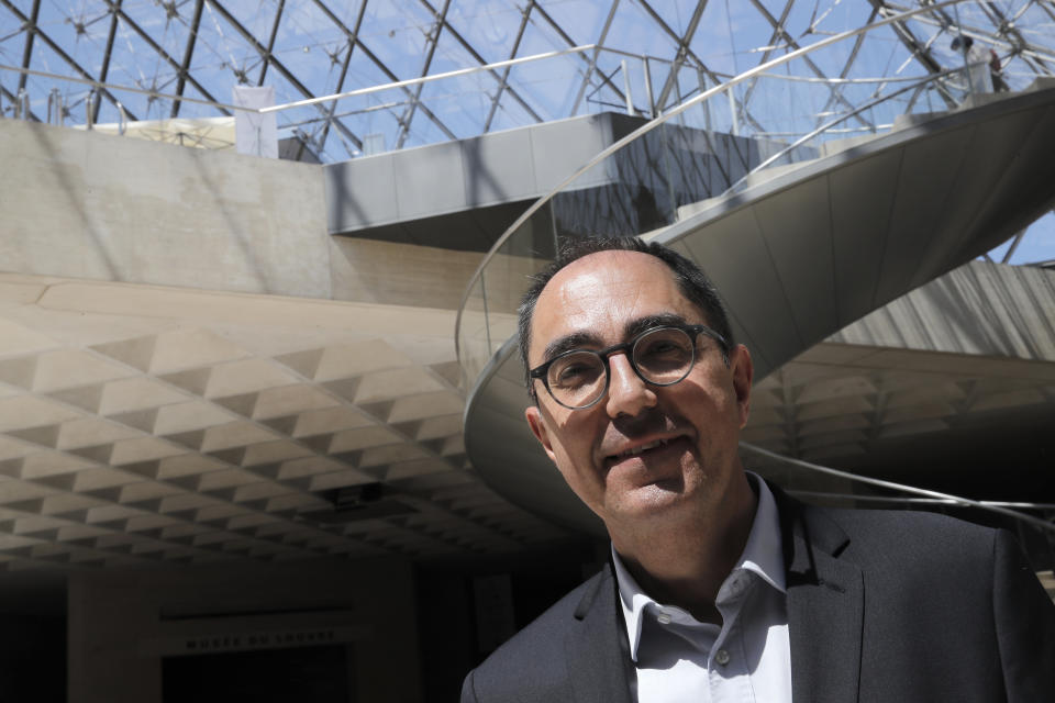 FILE - President-Director of the Louvre museum Jean-Luc Martinez poses during a visit of the Louvre museum Tuesday, June 23, 2020 in Paris. The former Louvre president has been given preliminary charges for antiques trafficking during his tenure as head of the world's most famous museum and home to the Mona Lisa. Jean-Luc Martinez was charged by Paris police Wednesday May 25, 2022 on counts of "complicity in organized fraud" and money laundering, according to the Paris prosecutors' office, which added that he remains under judicial control. (AP Photo/Christophe Ena, File)