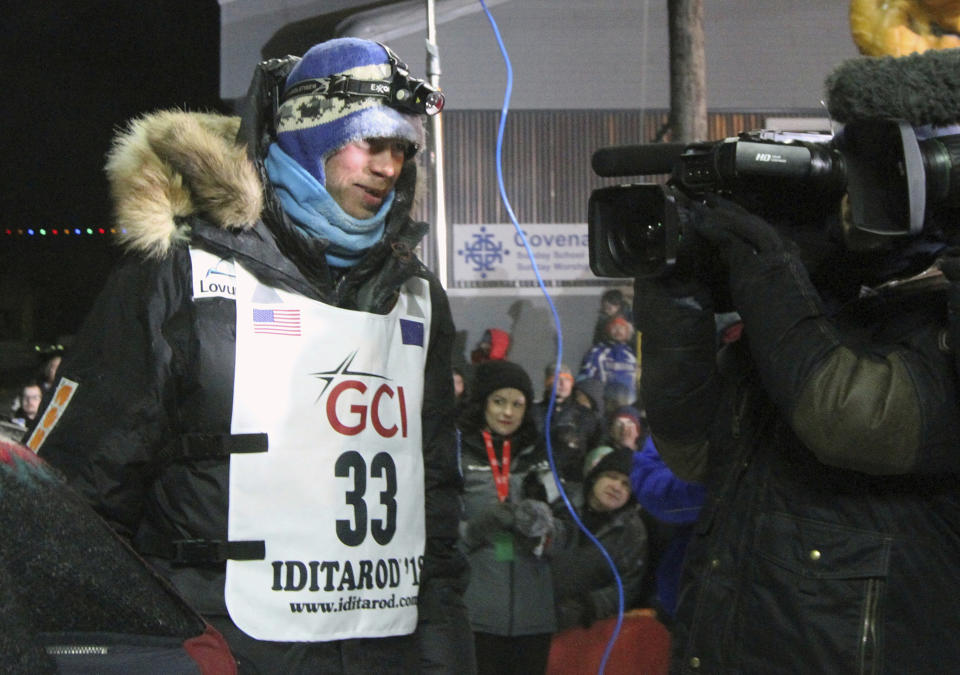 FILE - In this March 14, 2018, file photo, Joar Leifseth Ulsom, of Norway is interviewed after winning the Iditarod Trail Sled Dog Race in Nome, Alaska. Alaska’s famed Iditarod Trail Sled Dog race kicks off this weekend. Defending champion Ulsom and 51 other mushers officially begin the competitive portion of the Iditarod race on Sunday, March 3, 2019, in Willow, north of Anchorage. The race across Alaska’s wilderness will take about nine days before the winner reaches the famed burled arch in downtown Nome. (AP Photo/Diana Haecker, File)