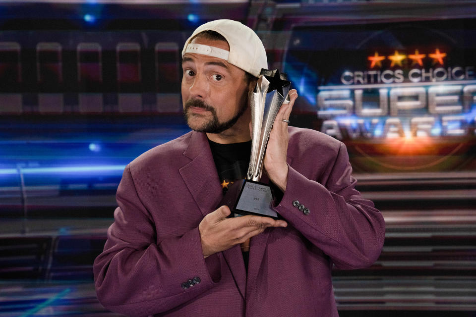 <p>Kevin Smith, who will share hosting duties for the Critics' Choice Super Awards, poses with the award in L.A.</p>