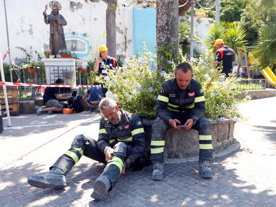 <p>Firefighters take a rest after an earthquake hits the island of Ischia, off the coast of Naples, Italy, Aug. 22, 2017. (Photo: Ciro De Luca/Reuters) </p>