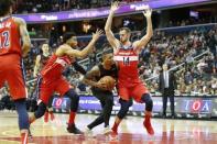 Nov 18, 2018; Washington, DC, USA; Portland Trail Blazers guard Damian Lillard (0) dribbles the ball between Washington Wizards forward Otto Porter Jr. (22) and Wizards forward Jason Smith (14) during the second half at Capital One Arena. Mandatory Credit: Amber Searls-USA TODAY Sports