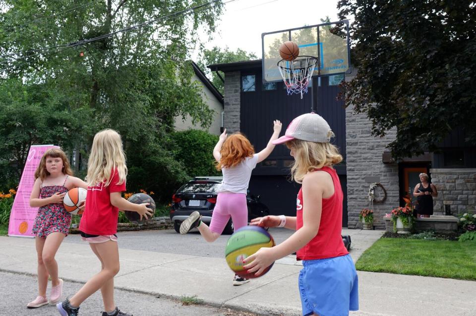  Neighbourhood kids play basketball outside Rosalind Paciga's home on Beech Street.              