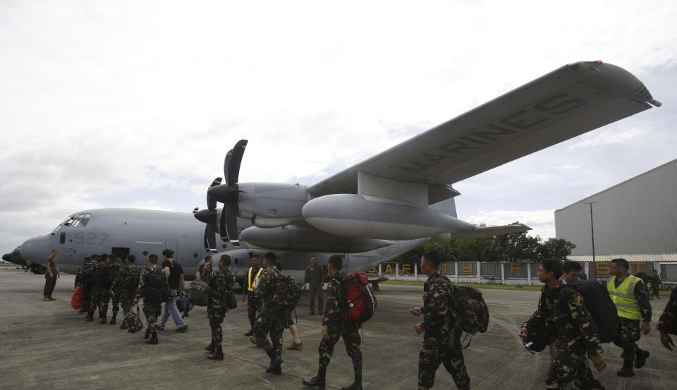 Members of Philippine Army prepare to board a U.S. C-130 plane at Villamor Air Base