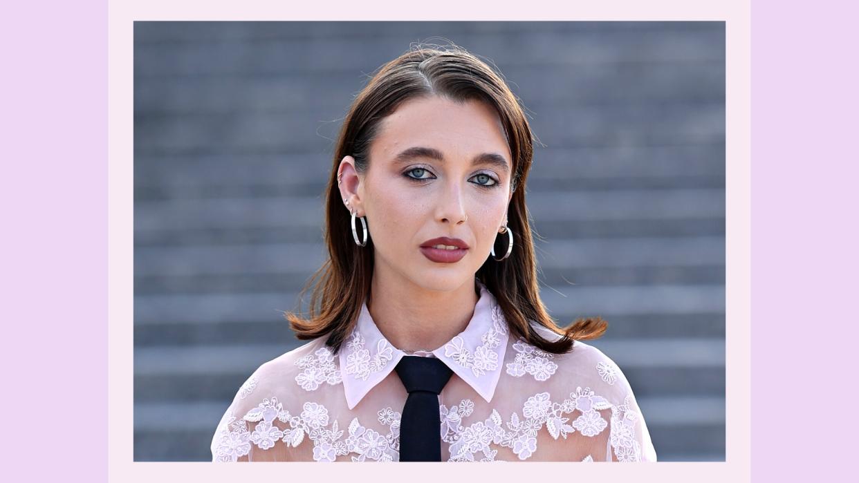  Emma Chamberlain pictured wearing a sheet pink floral top and sheer eyeshadow, with black eyeliner at the  Valentino Haute Couture Fall/Winter 2023/2024 show as part of Paris Fashion Week at Chateau de Chantilly on July 05, 2023 in Chantilly, France/ in a purple template 