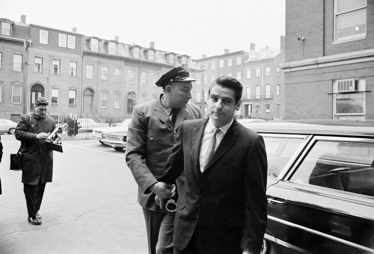 Albert DeSalvo, right, arrives for a court appearance in Cambridge on Jan. 10, 1967. A judge sentenced DeSalvo, a factory worker who claimed he was the notorious Boston Strangler, but questions still swirl around DeSalvo's confession.