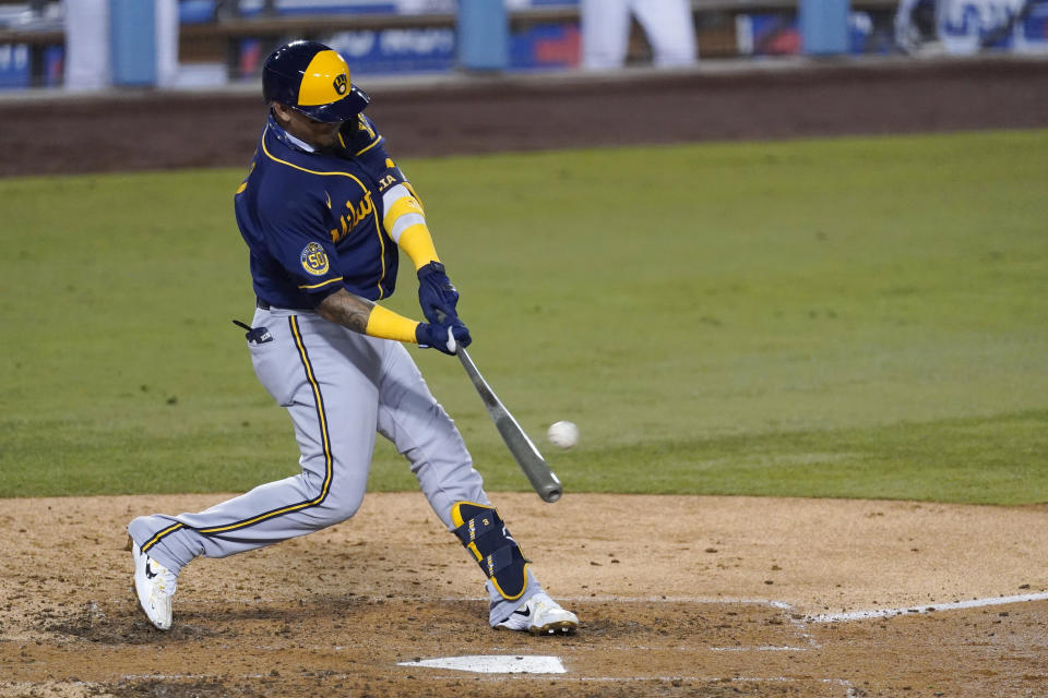 Milwaukee Brewers' Orlando Arcia connects for a two-run home run during the fourth inning in Game 1 of the team's National League wild-card baseball series against the Los Angeles Dodgers on Wednesday, Sept. 30, 2020, in Los Angeles. (AP Photo/Ashley Landis)