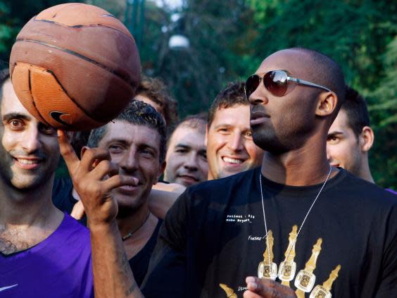 Bryant plays with a ball during a sponsor’s event in Milan during 2011 (AP)