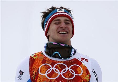 Winner Austria's Matthias Mayer reacts on podium after the men's alpine skiing downhill race during the 2014 Sochi Winter Olympics at the Rosa Khutor Alpine Center February 9, 2014. REUTERS/Leonhard Foeger