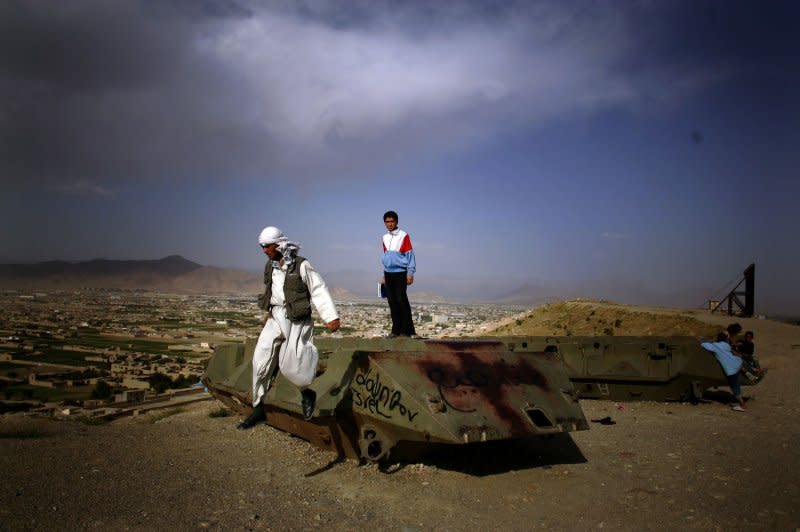 A man jumps down off of a damaged Soviet-era tank in Kabul, Afghanistan, on September 2, 2009. On February 5, 1989, the last Soviet troops left Kabul, ending a nearly decadelong involvement in a war between Afghanistan's communist government and Muslim rebels. File Photo by Mohammad Kheirkhah/UPI