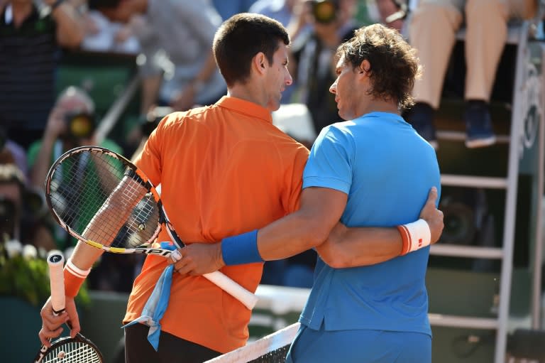 Rafael Nadal (right) and Novak Djokovic embrace at the end of their quarter-final at the 2015 French Open