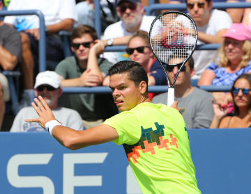 Aug 30, 2014; New York, NY, USA; Milos Raonic (CAN) returns a shot to Victor Estrella Burgos (DOM) on the Grandstand Court on day six of the 2014 U.S. Open tennis tournament at USTA Billie Jean King National Tennis Center. (Anthony Gruppuso-USA TODAY Sports)