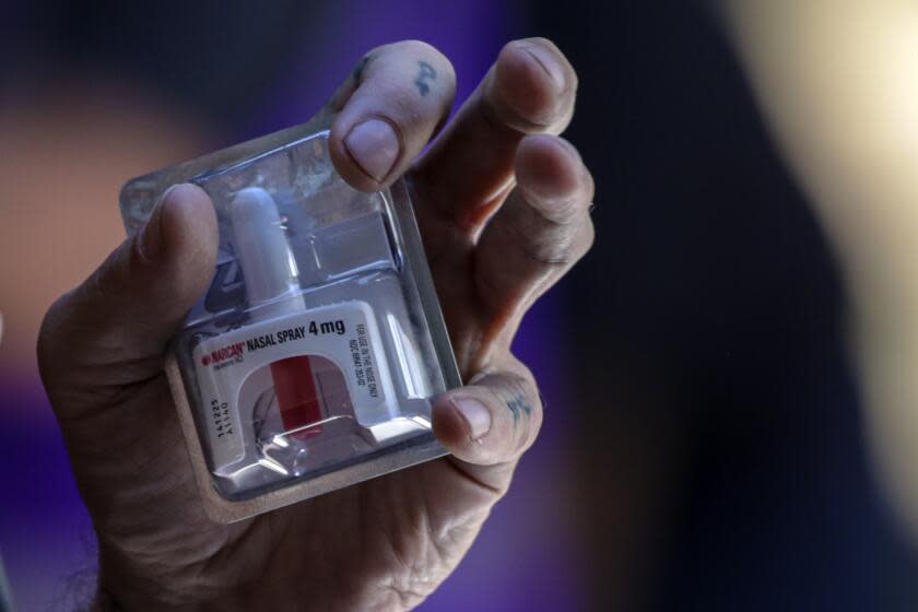 Los Angeles, CA - August 31: Spider Davila, from LA Community Health Project, describes the usage of a nasal spray that reverses the effects of an opioid overdose at rally held to mark International Overdose Awareness Day outside City Hall on Wednesday, Aug. 31, 2022 in Los Angeles, CA. (Irfan Khan / Los Angeles Times)