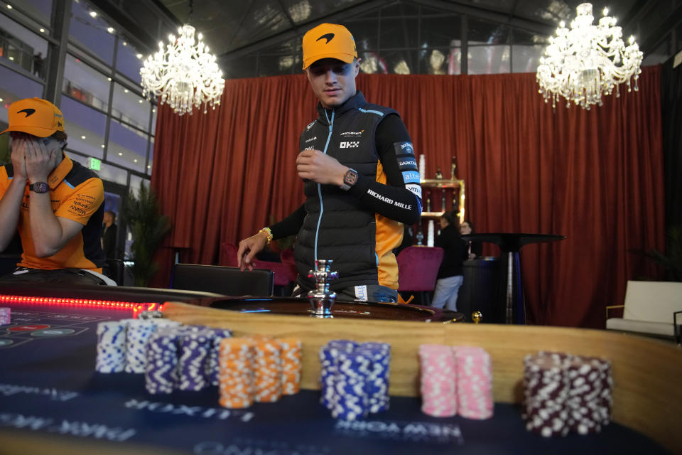 McLaren driver Oscar Piastri, of Australia, left, and McLaren driver Lando Norris, of Britain, play at a mock roulette table before an opening ceremony for the Formula One Las Vegas Grand Prix auto race, Wednesday, Nov. 15, 2023, in Las Vegas. (AP Photo/John Locher)