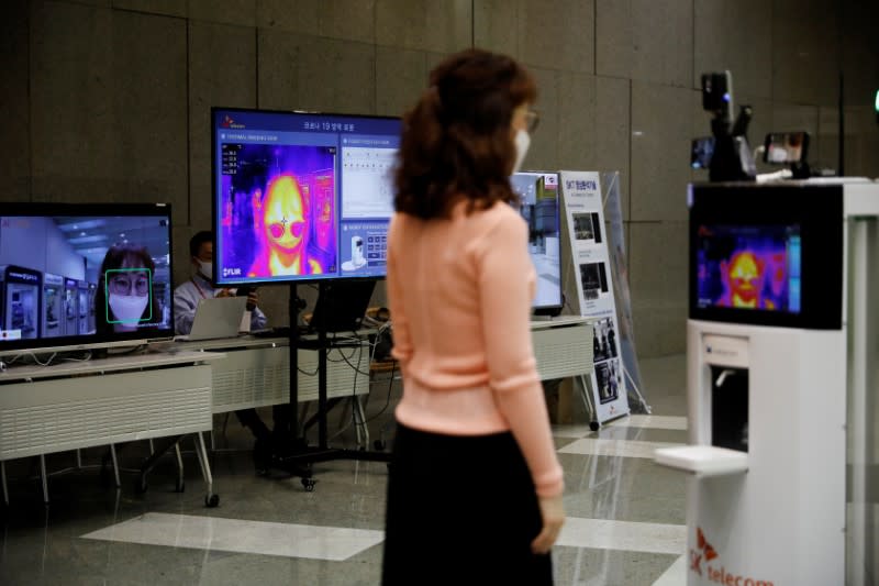 A self-driving robot checks the body temperature of an employee during its demonstration at the headquarters of SK Telecom in Seoul