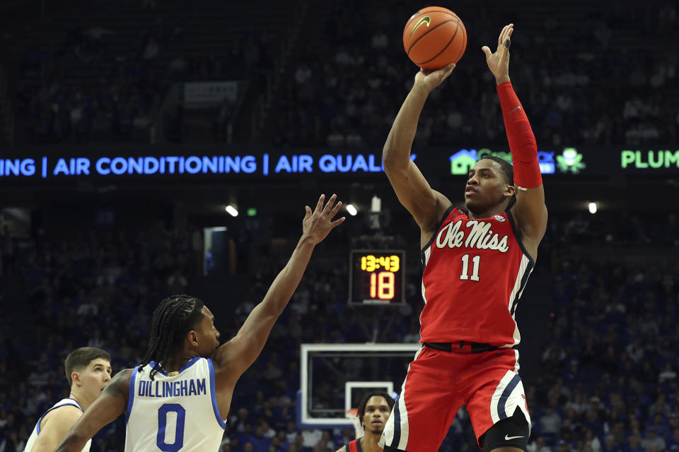 Mississippi's Matthew Murrell (11) shoots over the defense of Kentucky's Rob Dillingham (0) during the first half of an NCAA college basketball game Tuesday, Feb. 13, 2024, in Lexington, Ky. Kentucky won 75-63. (AP Photo/James Crisp)