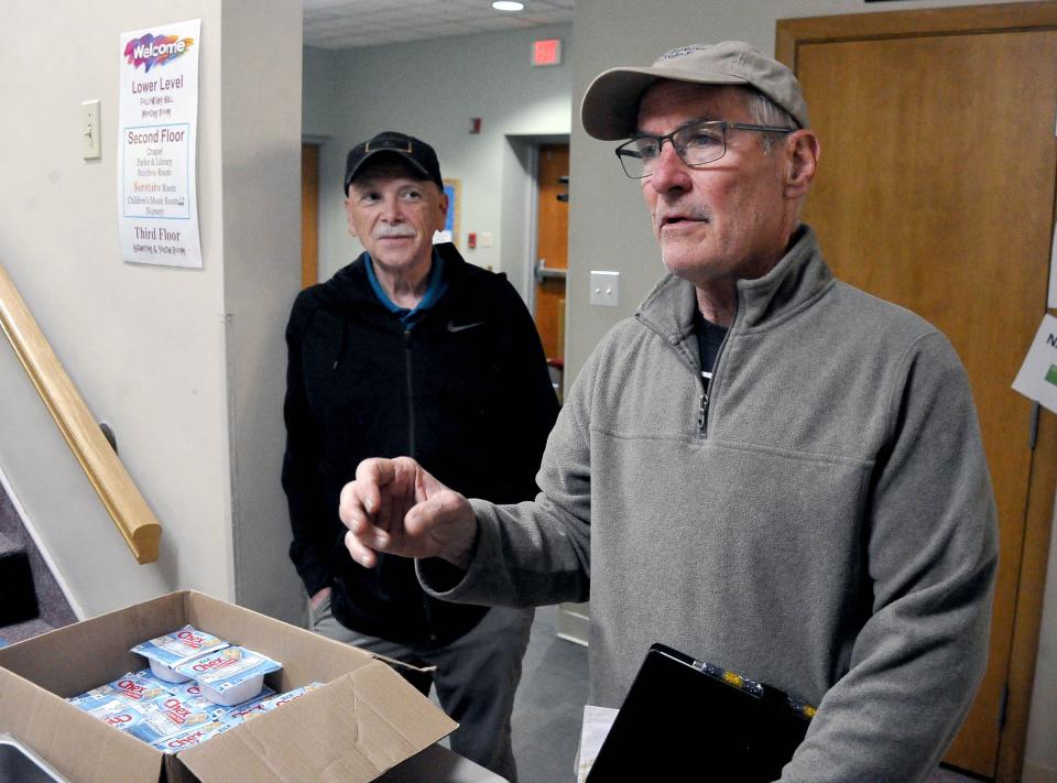 Over almost 30 years, the Trinity United Church of Christ breakfast program has served an estimated 452,680 meals, says Mike Lilburn, shown with the Rev. Kevan Franklin.