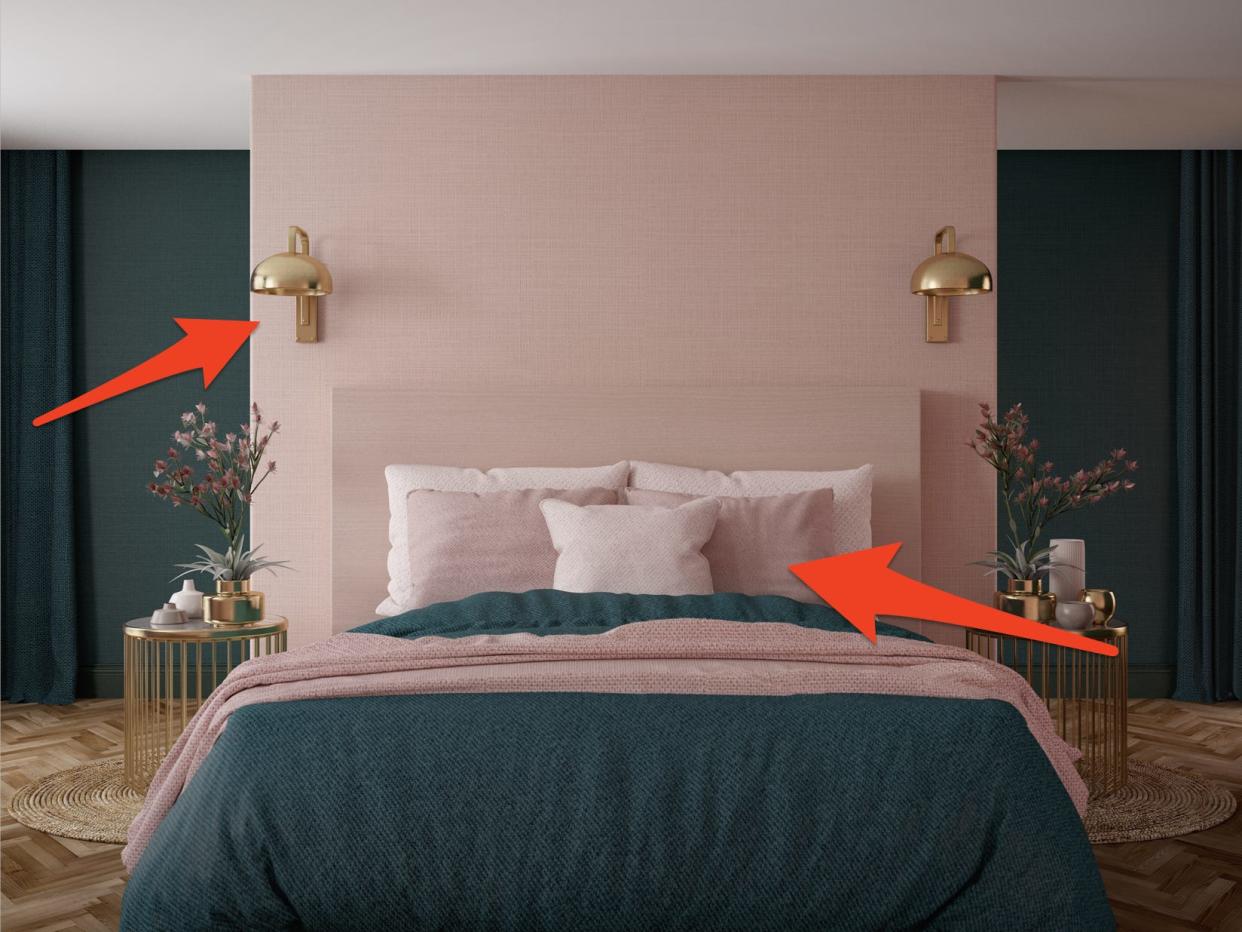 Pink and blue bedroom with wall sconces, a colorful bed, and gold side tables