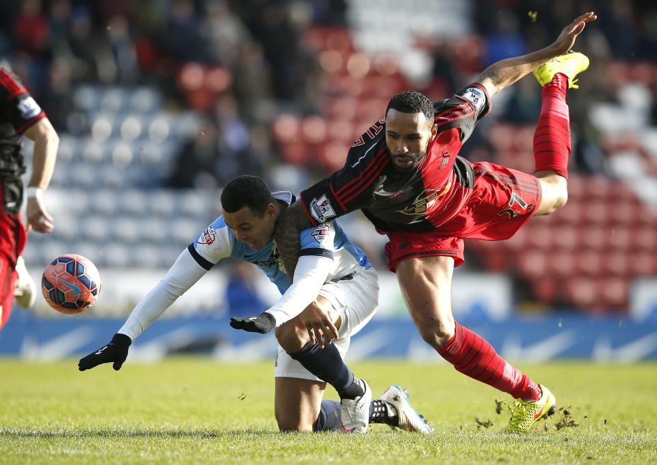 Blackburn Rovers' Joshua King (L) is fouled by Swansea City's Kyle Bartley, resulting in a red card for Bartley, during their FA Cup fourth round soccer match at Ewood Park in Blackburn, northern England January 24, 2015. REUTERS/Andrew Yates (BRITAIN - Tags: SPORT SOCCER)