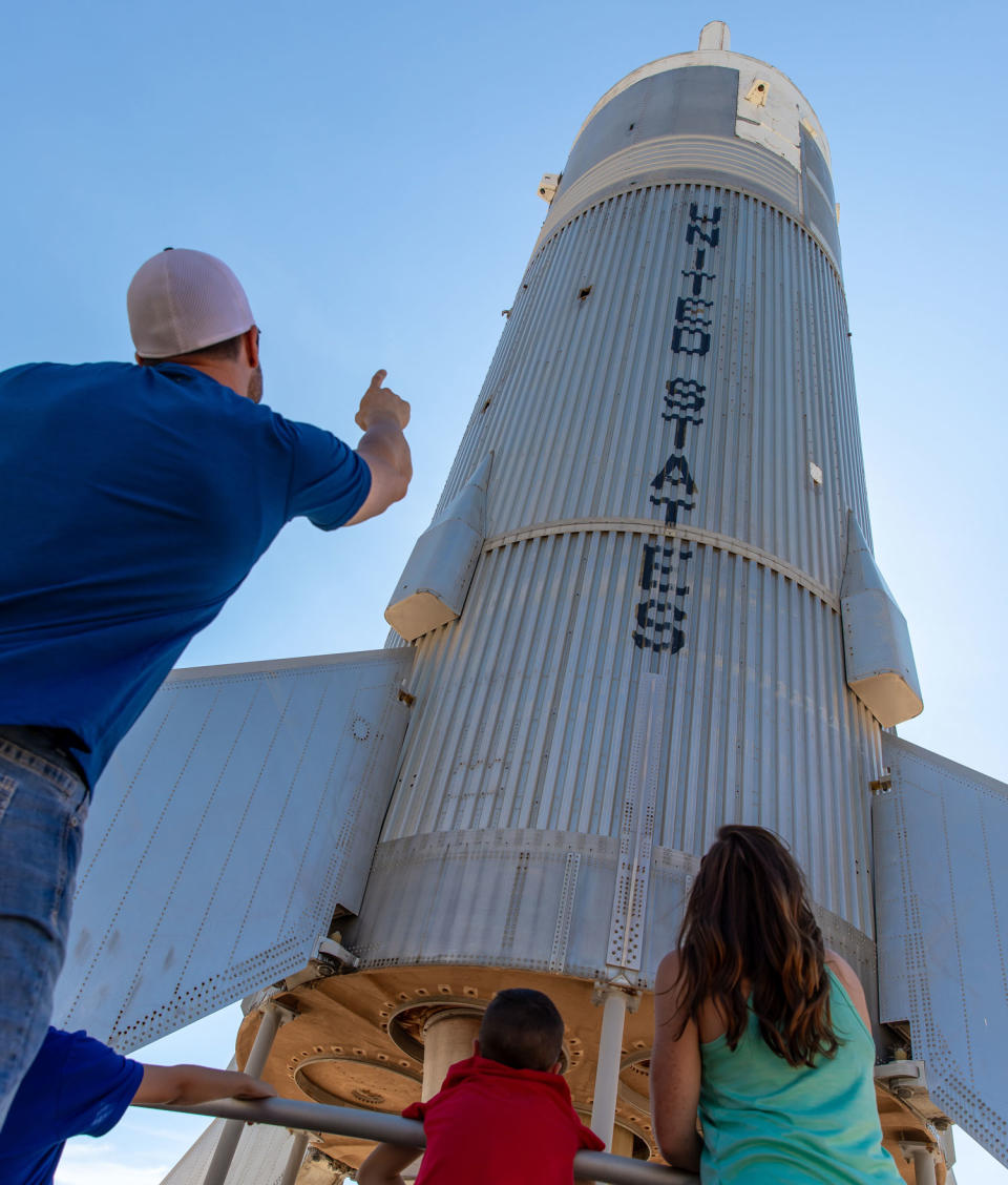 A family gazes up at a rocket at the New Mexico Museum of Space History in Alamogordo, N.M.