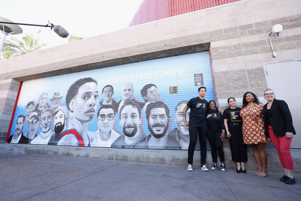 Brittney Griner with wife Cherelle Griner, Neda Sharghi, artist Antoinette Cauley and Arizona Governor Katie Hobbs pose alongside the 